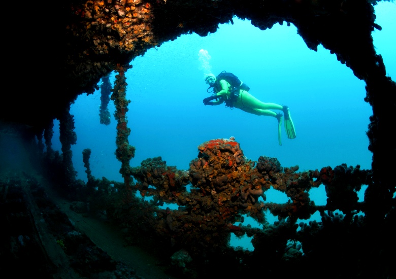 Scuba diver in the shipwreck of Baron Gautsch