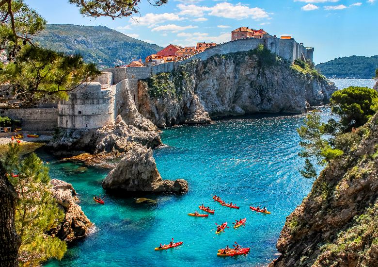 Bokar Fortress and view of Dubrovnik city walls with kayakers in the turquoise water