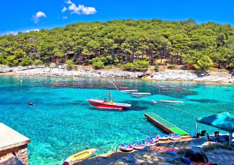 View of Cikat Bay with boats floating on turquoise water on Losinj Island