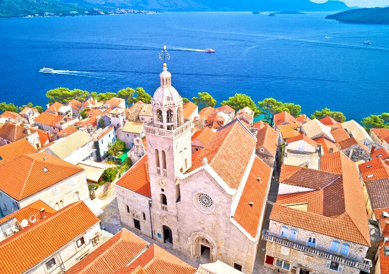 View of Korcula old town roofs with blue water in the background