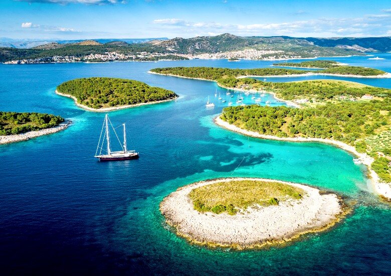 View of Paklinski Islands with a sailing boat and turquoise water