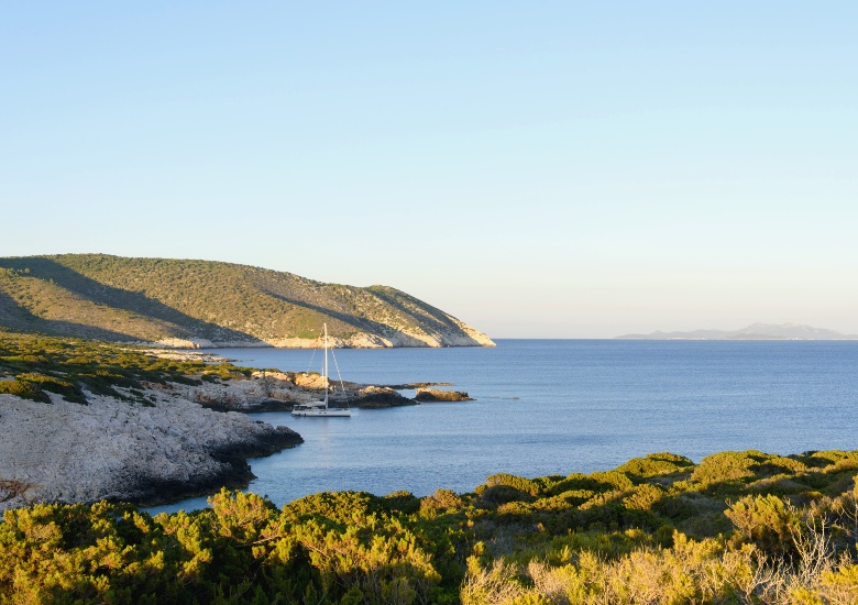 View of green island and sailing boat in the distance of Susac Island